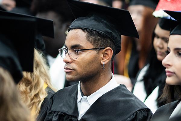 Student wearing cap and gown at graduation 