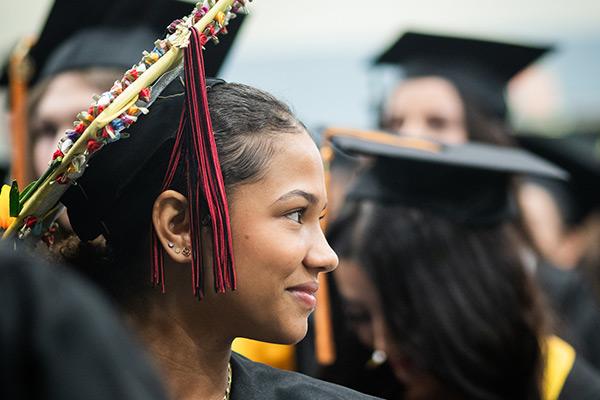 Graduation student smiling and looking off to the side