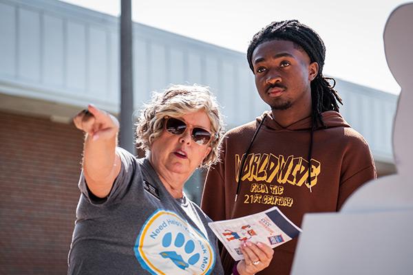 College employee directing student 