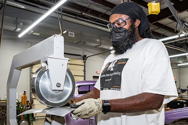 Minority student within auto restoration class