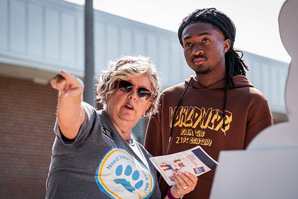 Faculty member pointing student in the proper direction 