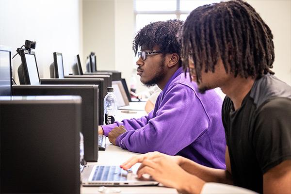 Row of students working on computers in computer lab