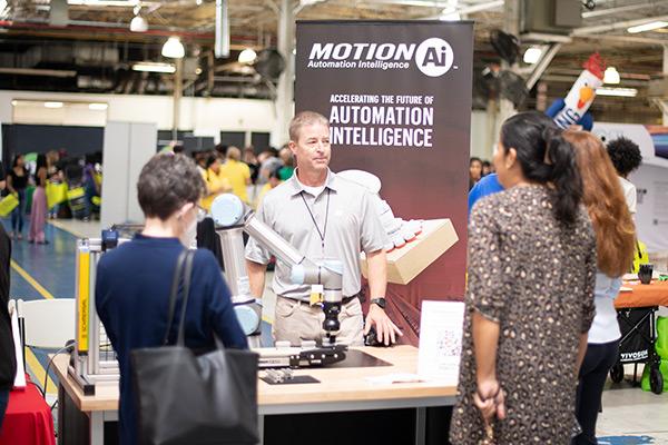 Folks talking to vendor at National Manufacturing Day