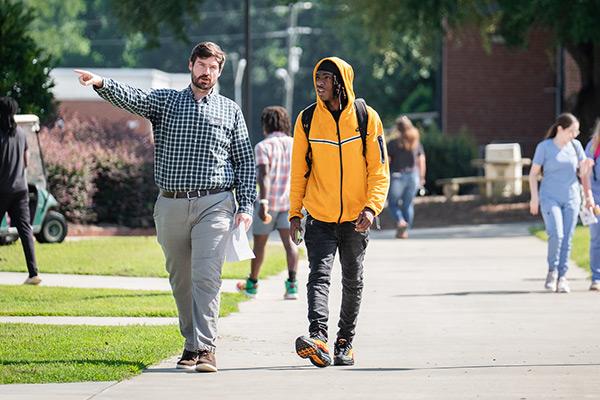 College employee giving future student a preview of the college 